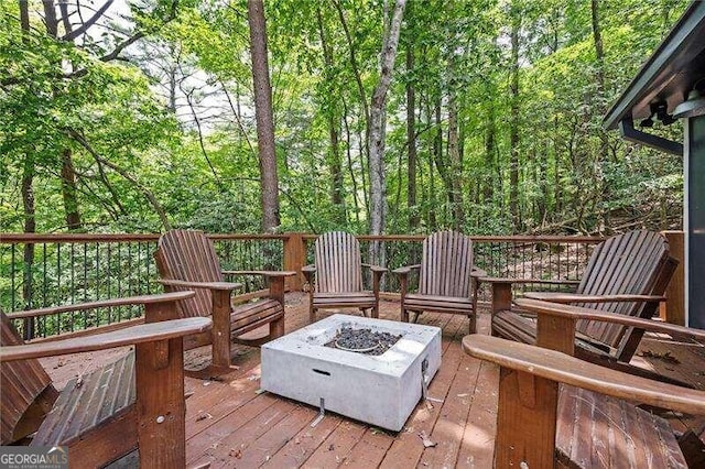 wooden deck with a fire pit