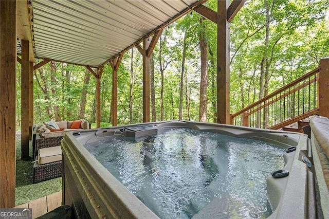 view of pool with a hot tub