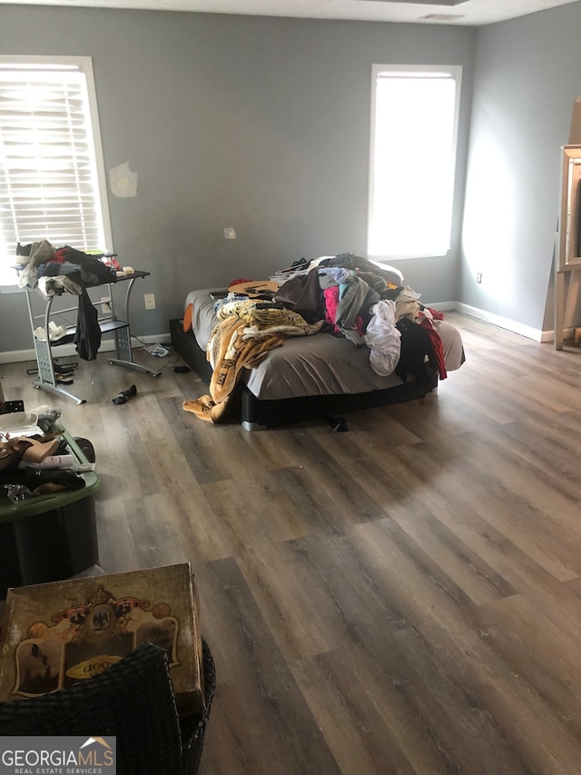 bedroom featuring multiple windows and hardwood / wood-style floors