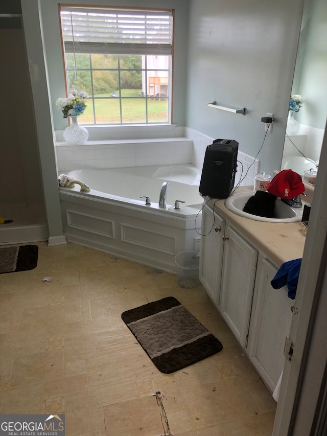 bathroom with vanity and a bath