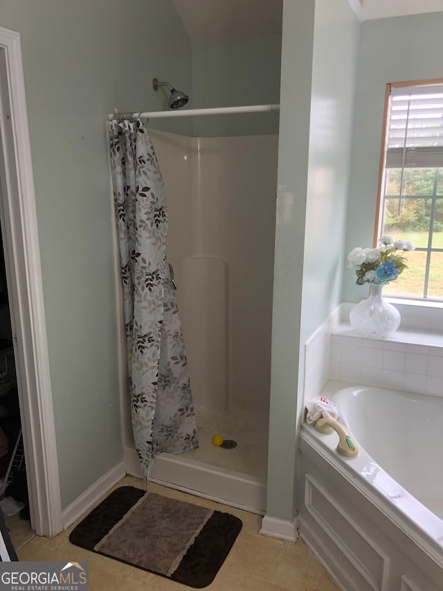 bathroom featuring tile patterned flooring and separate shower and tub