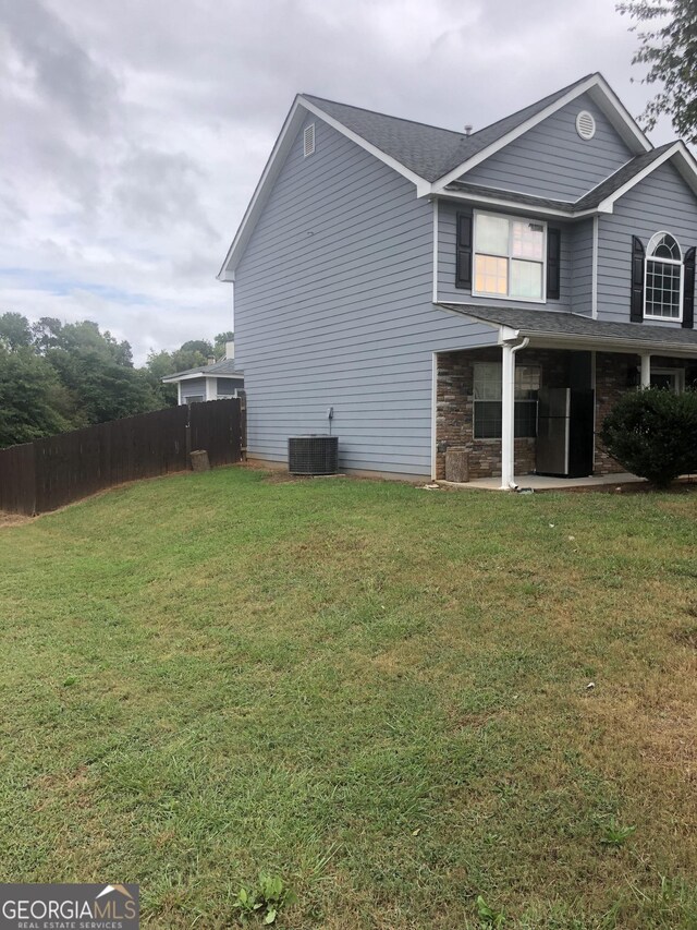 view of property exterior featuring a lawn and central AC unit