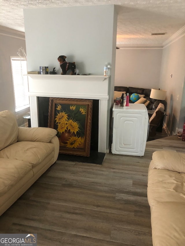 living room featuring a textured ceiling, crown molding, and dark hardwood / wood-style flooring