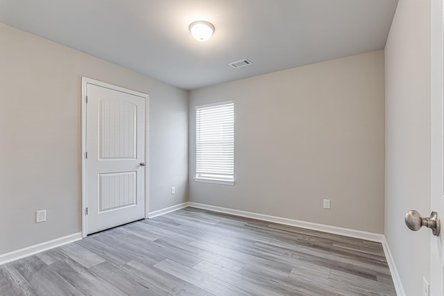 spare room featuring hardwood / wood-style floors