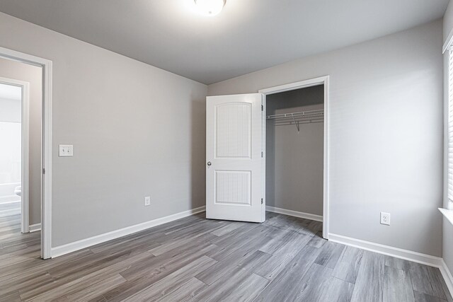 unfurnished bedroom with a closet and wood-type flooring