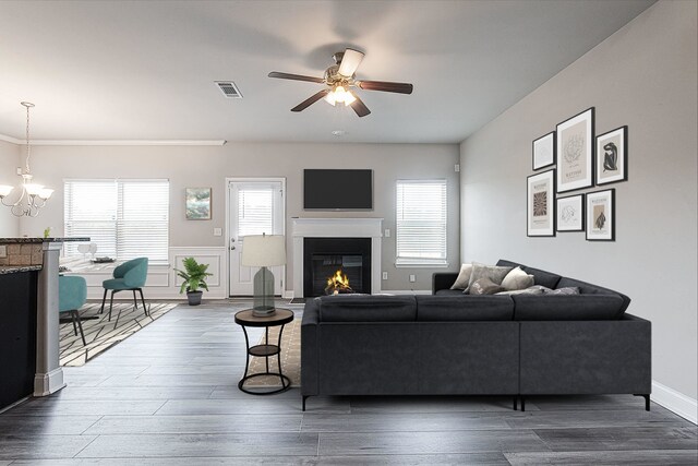 living room featuring ceiling fan with notable chandelier and hardwood / wood-style floors