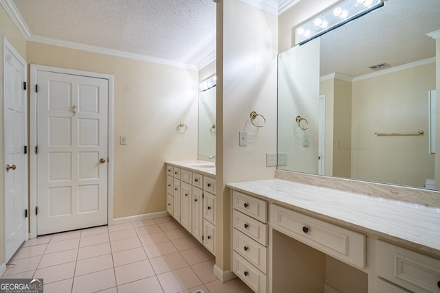 bathroom with vanity, crown molding, a textured ceiling, and tile patterned floors