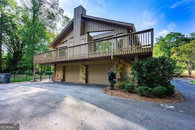 view of home's exterior featuring a garage and a wooden deck