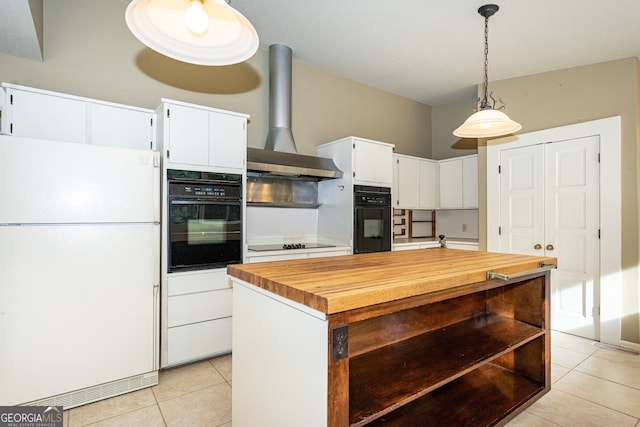 kitchen with hanging light fixtures, wall chimney range hood, white cabinetry, black appliances, and a center island