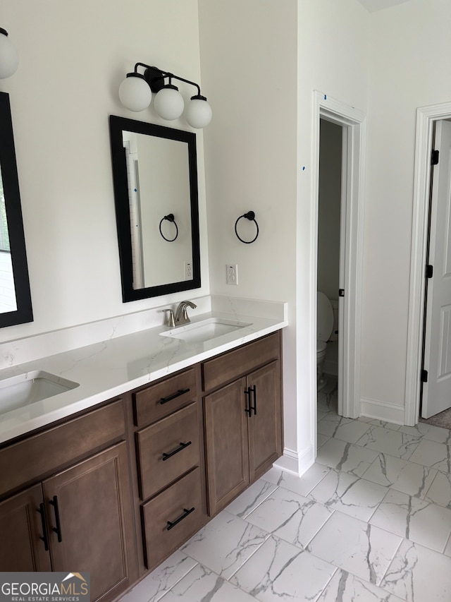 bathroom featuring vanity and toilet