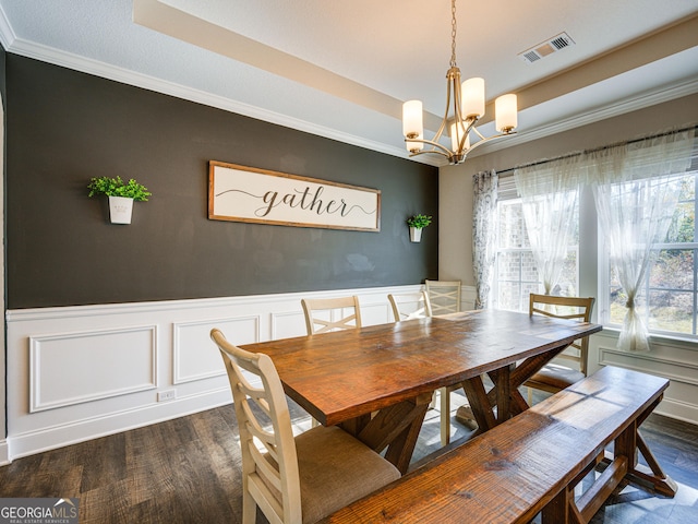 dining area with dark wood-style floors, a tray ceiling, a chandelier, and visible vents