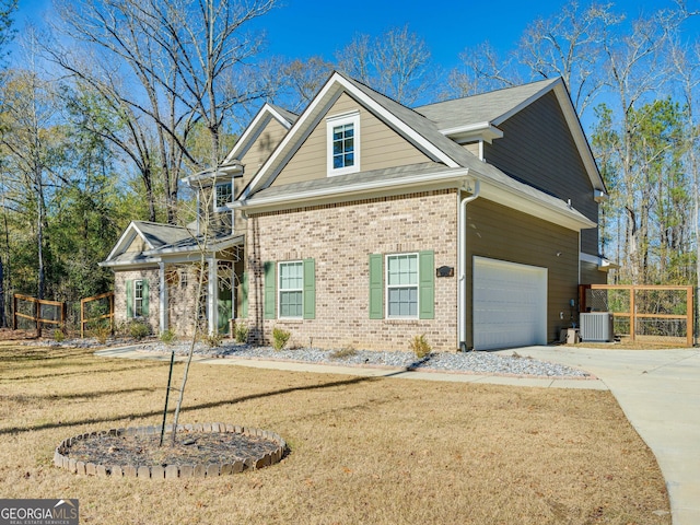 view of front of home with driveway, central AC unit, and brick siding