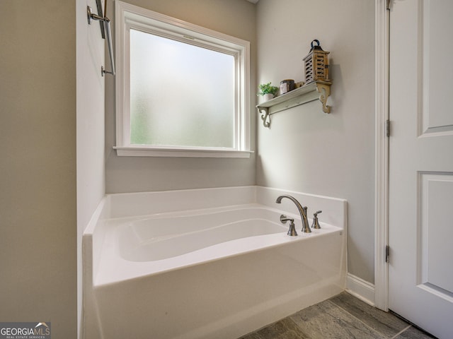 full bathroom featuring wood finished floors and a garden tub