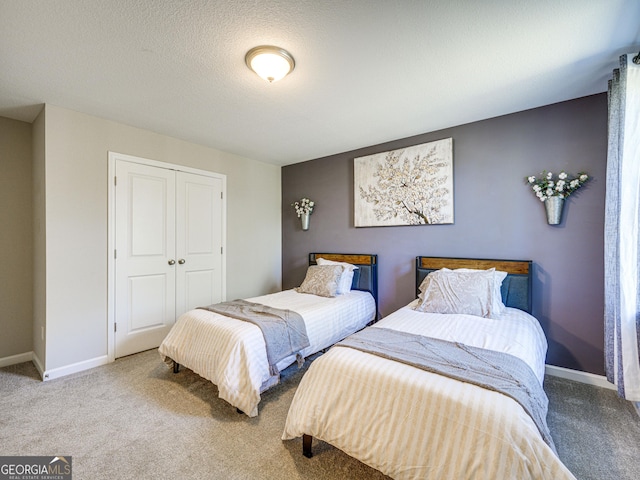 bedroom featuring carpet, a closet, and baseboards