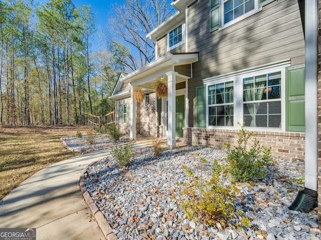 property entrance featuring brick siding