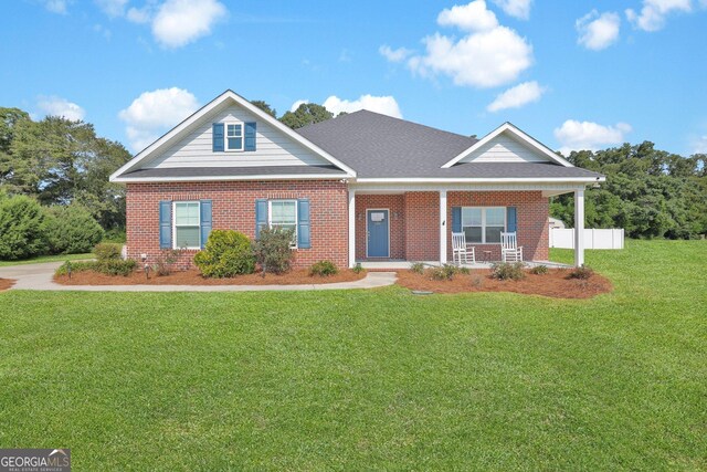 craftsman-style home featuring covered porch and a front yard