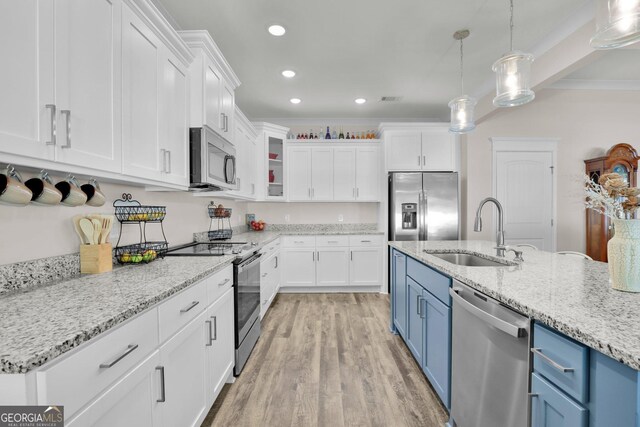 kitchen featuring stainless steel appliances, light hardwood / wood-style flooring, white cabinetry, sink, and blue cabinets