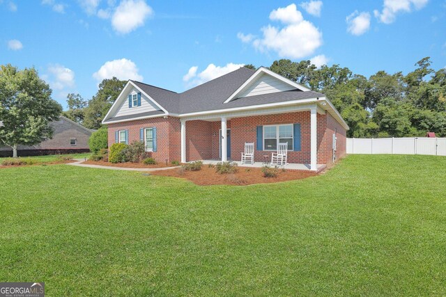 view of front of home with a front yard and covered porch