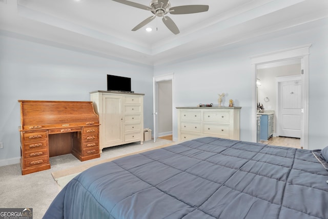 carpeted bedroom featuring ceiling fan and a raised ceiling