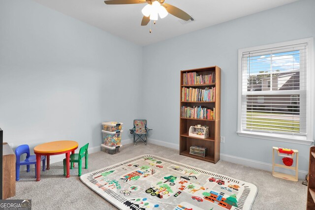 rec room with ceiling fan and light colored carpet