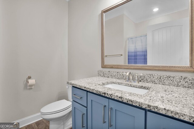 bathroom featuring toilet and vanity