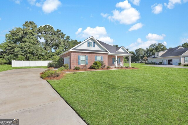 view of front of house featuring a front lawn, a garage, and a porch