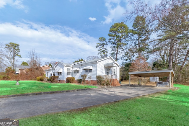 view of front facade with a carport and a front yard