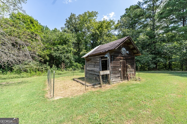 view of outdoor structure featuring a lawn