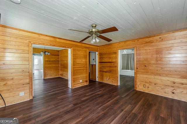 empty room featuring hardwood / wood-style flooring, wooden walls, and ceiling fan