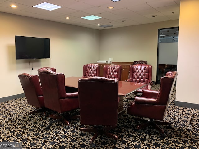 interior space with a paneled ceiling