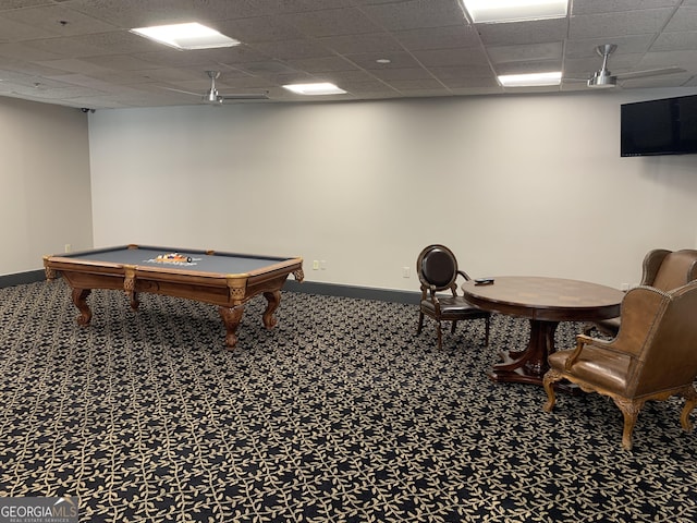 rec room with carpet floors, a drop ceiling, and baseboards