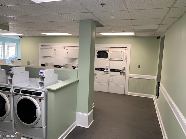 community laundry room featuring stacked washer and dryer, separate washer and dryer, and a wainscoted wall