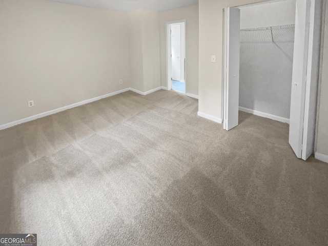 unfurnished bedroom with carpet floors, a closet, and baseboards