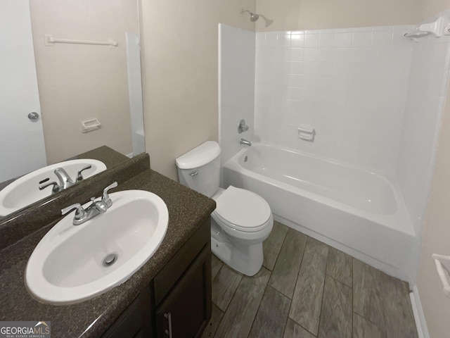 bathroom featuring wood tiled floor, tub / shower combination, vanity, and toilet