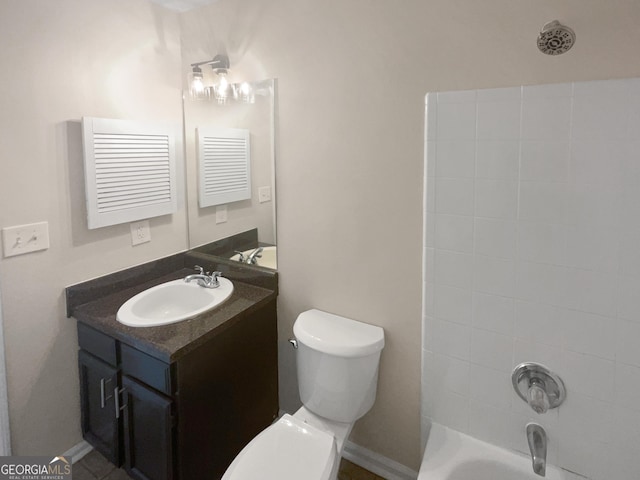 bathroom featuring toilet, tub / shower combination, and vanity