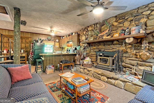 605 W Wildcat Rd, Clarkesville, GA 30523 - carpeted living area featuring ceiling fan, a wood stove, and wood walls