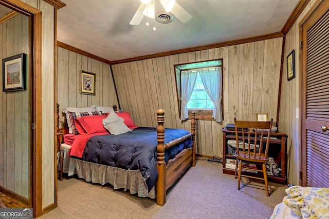 605 W Wildcat Rd, Clarkesville, GA 30523 - bedroom with ornamental molding, wood walls, a textured ceiling, carpet, and a ceiling fan