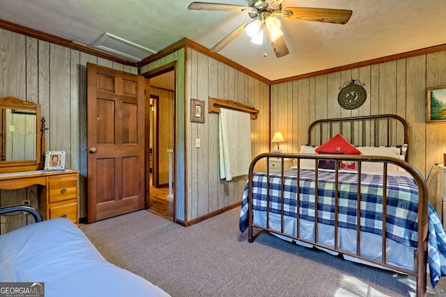 605 W Wildcat Rd, Clarkesville, GA 30523 - carpeted bedroom featuring ornamental molding, wooden walls, baseboards, ceiling fan, and a textured ceiling