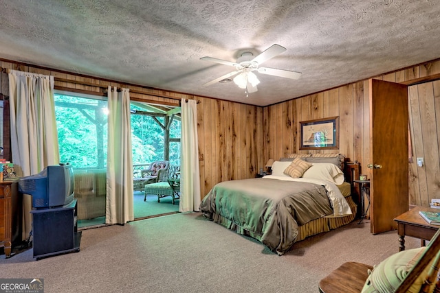 605 W Wildcat Rd, Clarkesville, GA 30523 - carpeted bedroom with access to outside, wooden walls, a textured ceiling, and ceiling fan