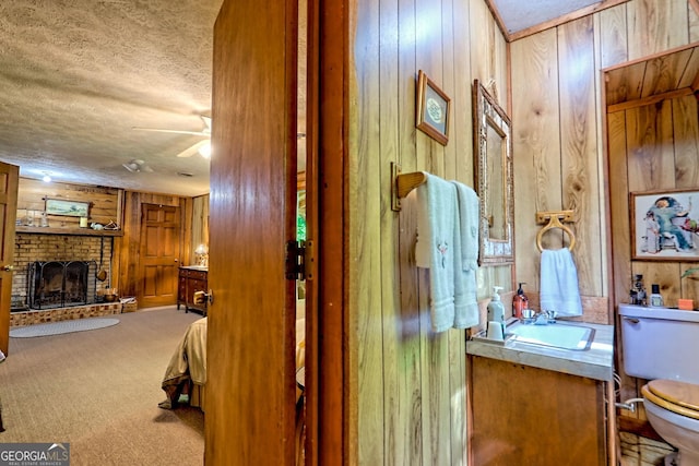605 W Wildcat Rd, Clarkesville, GA 30523 - corridor with wood walls, a textured ceiling, a sink, and carpet floors