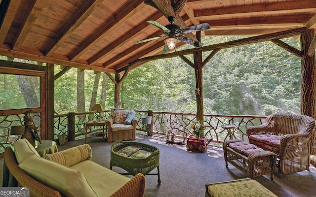 sunroom / solarium featuring lofted ceiling with beams, wood ceiling, and a ceiling fan