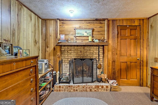 605 W Wildcat Rd, Clarkesville, GA 30523 - carpeted living room featuring wood walls, a textured ceiling, and a brick fireplace