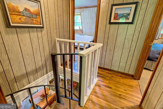 605 W Wildcat Rd, Clarkesville, GA 30523 - hallway featuring an upstairs landing, wood walls, hardwood / wood-style floors, and baseboards