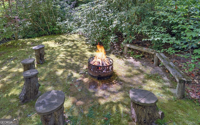 view of yard with a fire pit