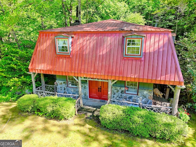 605 W Wildcat Rd, Clarkesville, GA 30523 - view of front of home featuring stone siding, metal roof, a wooded view, and a porch