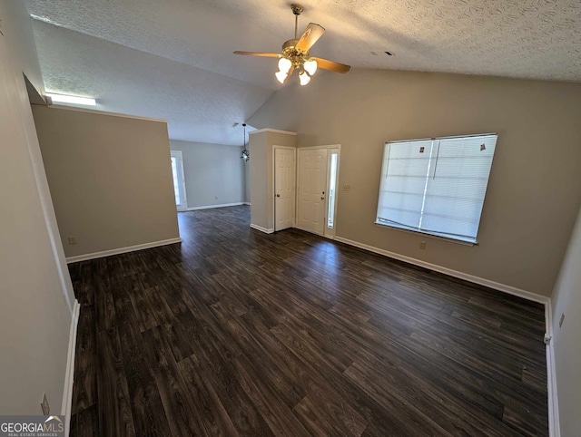 empty room featuring a textured ceiling, high vaulted ceiling, ceiling fan, and wood-type flooring