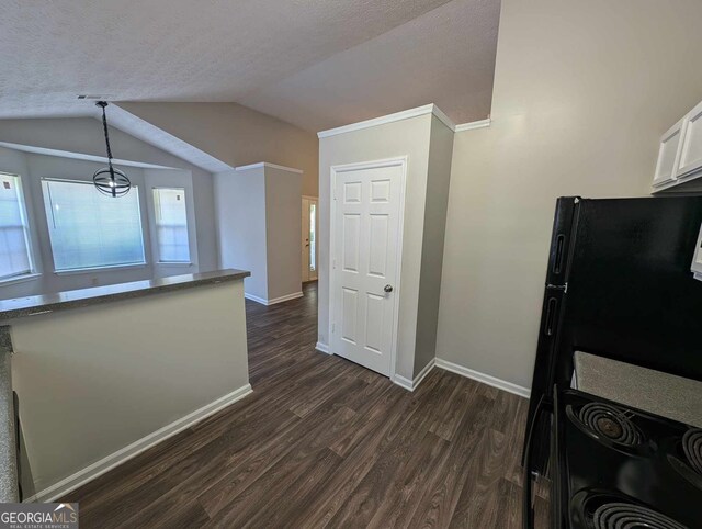 kitchen featuring dark hardwood / wood-style flooring, decorative light fixtures, lofted ceiling, a textured ceiling, and white cabinets