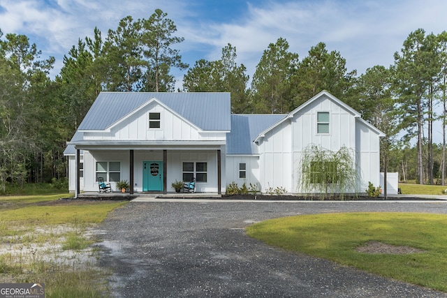 modern farmhouse with covered porch and a front yard