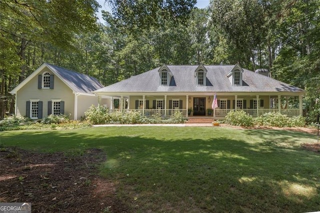 cape cod-style house featuring a front lawn and a porch