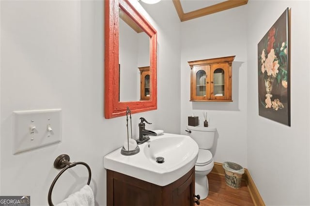 bathroom with wood-type flooring, toilet, and vanity